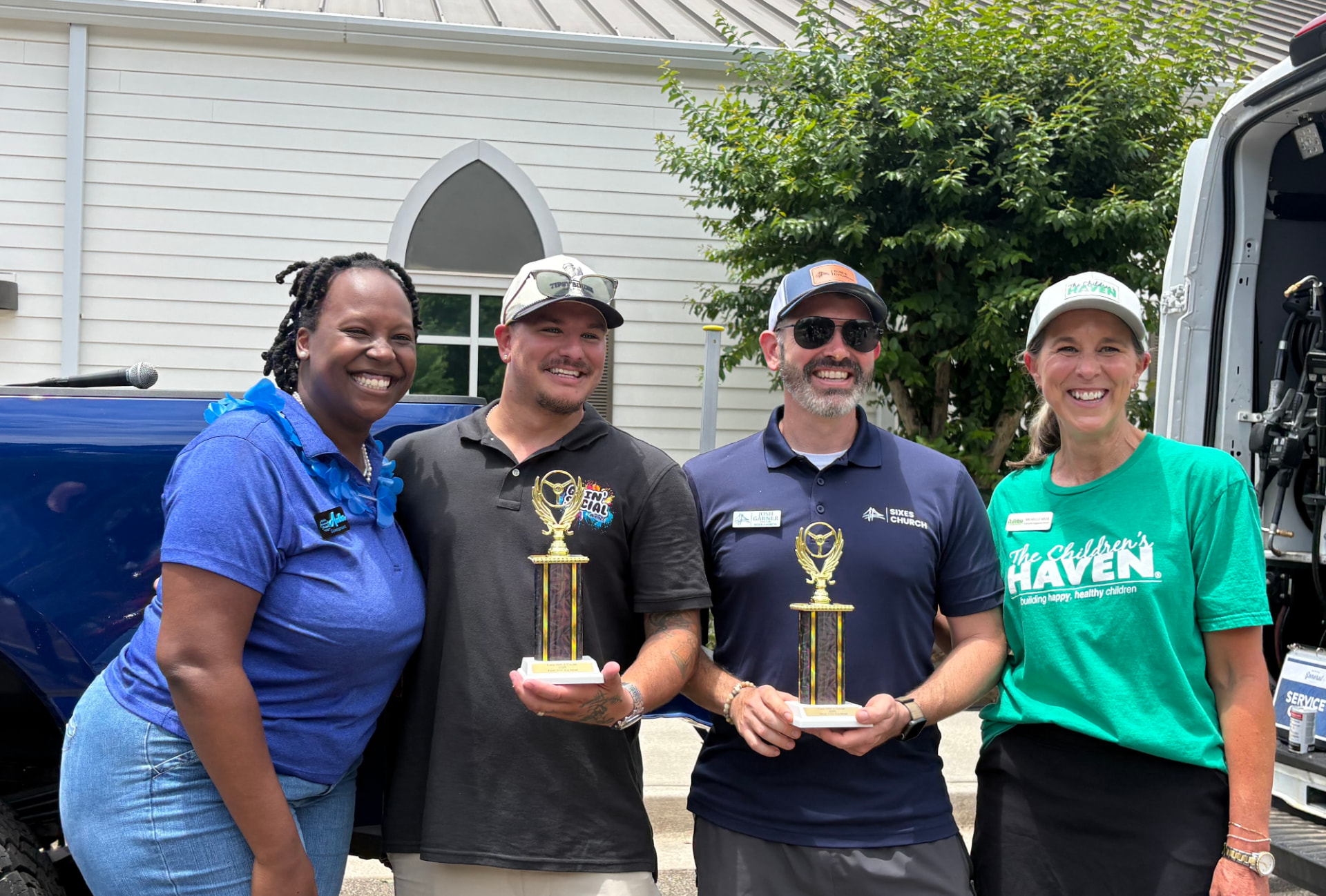 Goin' Social Events team with partners and award trophies at a community event